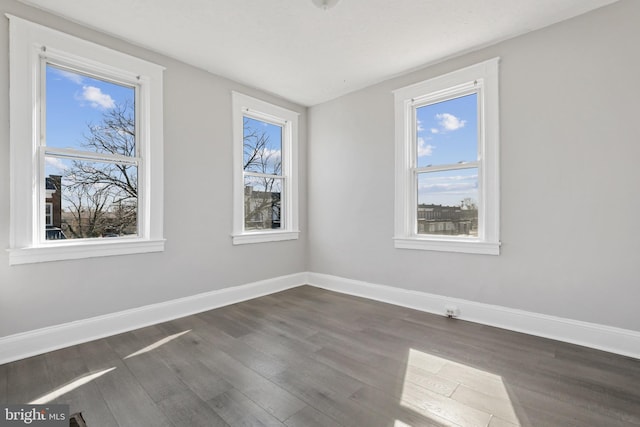 spare room with dark wood-type flooring