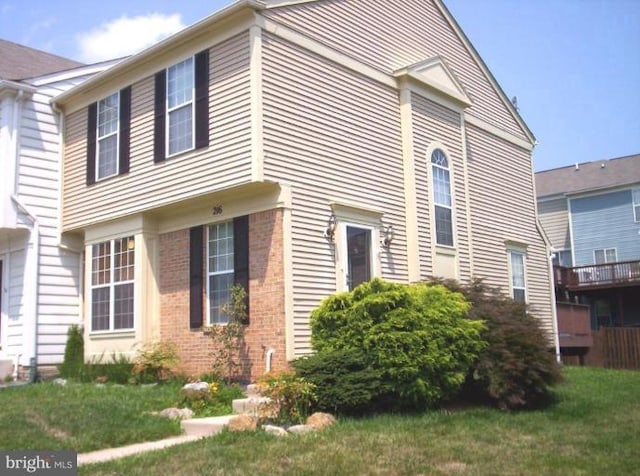 view of property exterior featuring a lawn