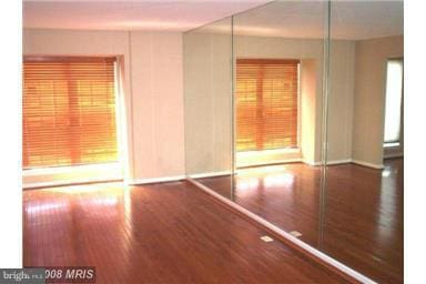 empty room with dark hardwood / wood-style floors