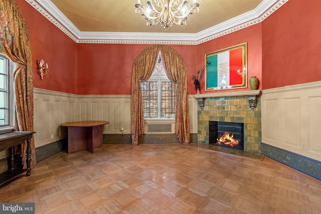 unfurnished living room featuring an inviting chandelier, ornamental molding, light parquet floors, and a high ceiling