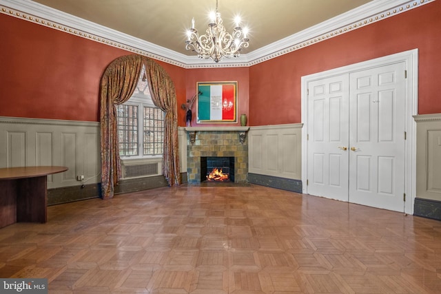 unfurnished living room featuring crown molding, an inviting chandelier, and parquet flooring