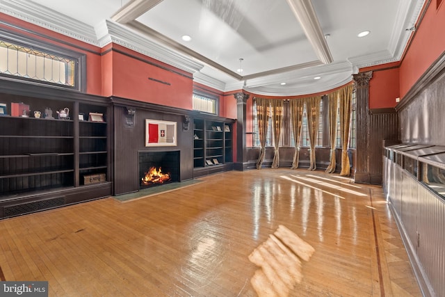 unfurnished living room with crown molding and ornate columns