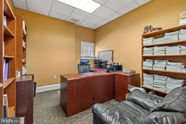 carpeted office with a drop ceiling