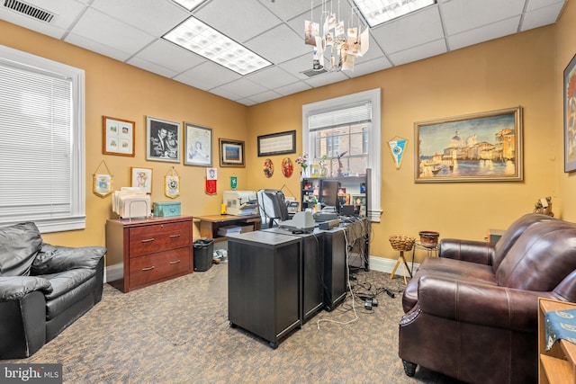 home office with a paneled ceiling, carpet floors, and an inviting chandelier