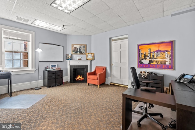 office space with carpet flooring and a drop ceiling