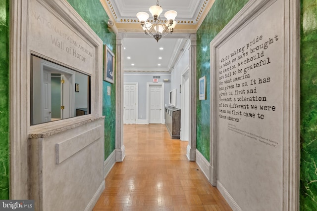 hall with light parquet floors, ornamental molding, a chandelier, and a tray ceiling