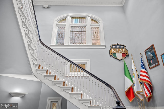 stairs featuring a towering ceiling