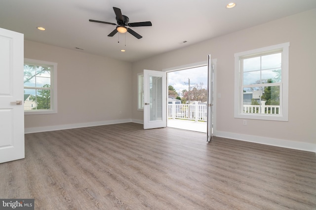 spare room featuring light hardwood / wood-style floors and a healthy amount of sunlight