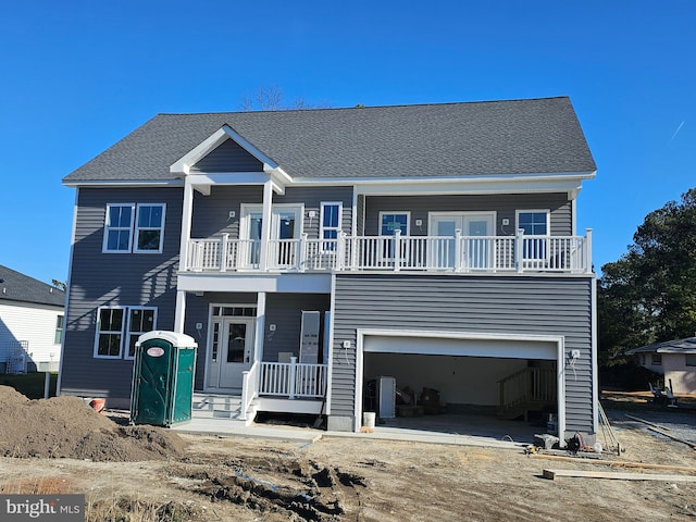 view of front of property with a balcony and a garage