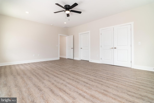 unfurnished bedroom featuring ceiling fan and light hardwood / wood-style floors