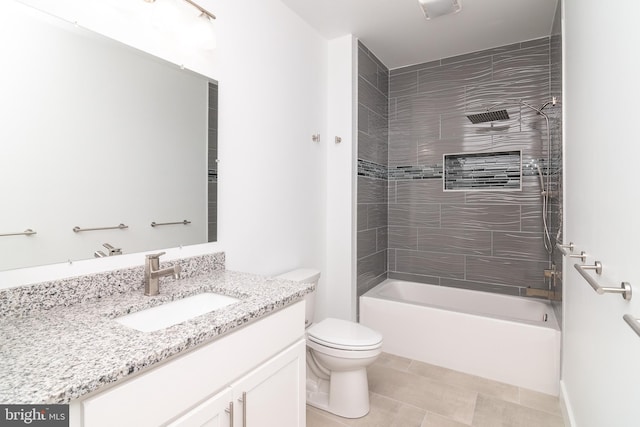 full bathroom featuring tiled shower / bath combo, vanity, tile patterned flooring, and toilet