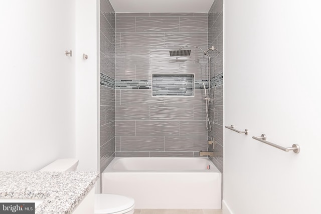 full bathroom featuring vanity, toilet, and tiled shower / bath