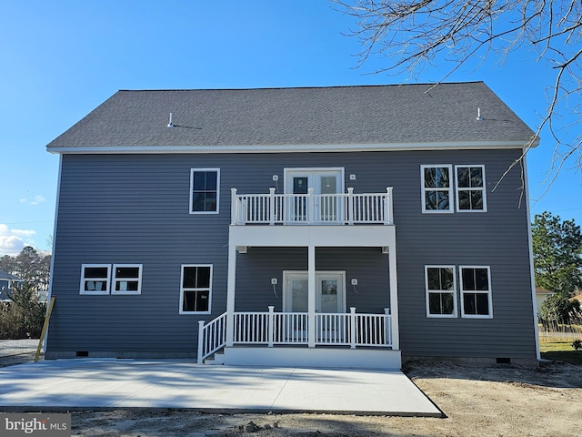 rear view of property with a balcony and a patio area