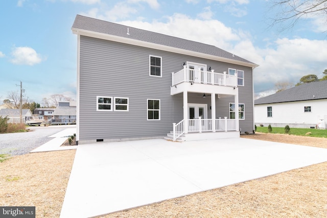 rear view of property featuring a balcony