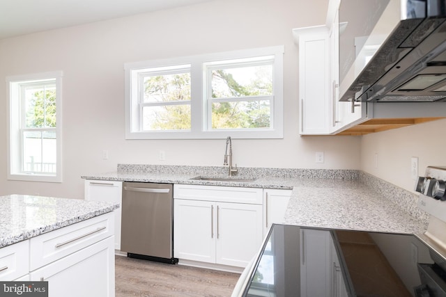 kitchen featuring white cabinetry, light hardwood / wood-style flooring, dishwasher, light stone countertops, and sink