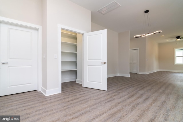 interior space with hardwood / wood-style floors and ceiling fan