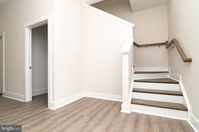 stairs with hardwood / wood-style floors