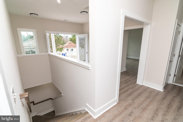 hall with hardwood / wood-style flooring