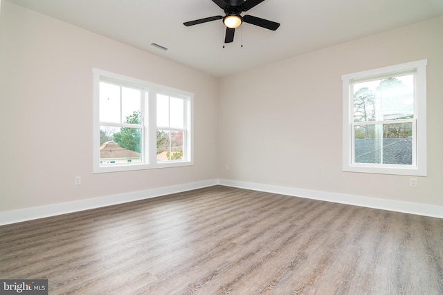 empty room with light hardwood / wood-style flooring and ceiling fan