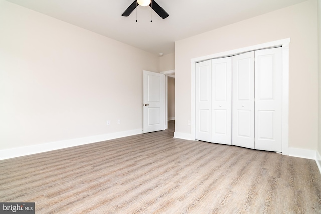 unfurnished bedroom featuring ceiling fan, light hardwood / wood-style flooring, and a closet