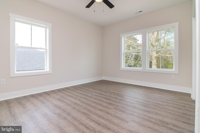 spare room with hardwood / wood-style floors and ceiling fan