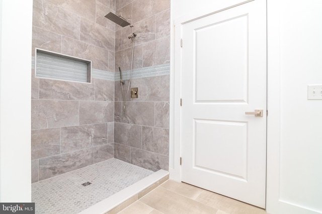 bathroom featuring a tile shower and tile patterned floors