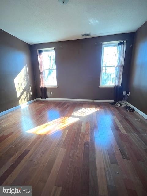 unfurnished room featuring dark wood-type flooring