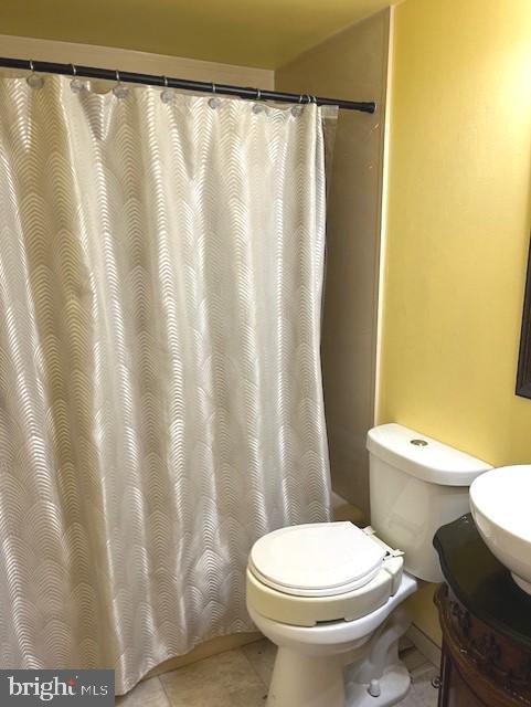 bathroom with vanity, toilet, and tile floors