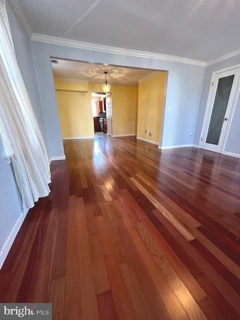 interior space with crown molding and dark hardwood / wood-style floors