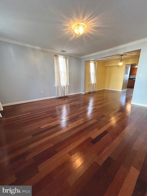 unfurnished room with ornamental molding and dark hardwood / wood-style flooring