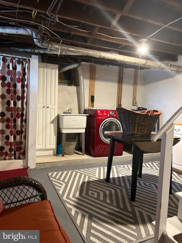 basement featuring washing machine and clothes dryer and sink