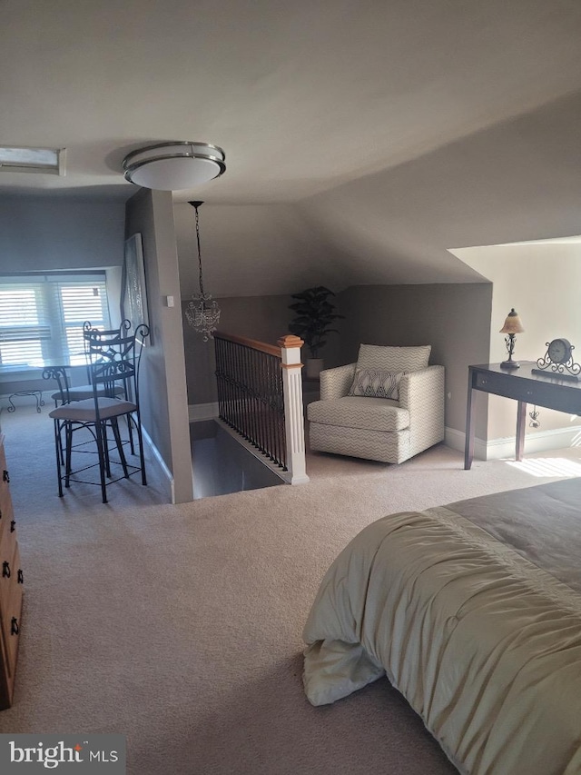 bedroom with a chandelier, carpet, and vaulted ceiling