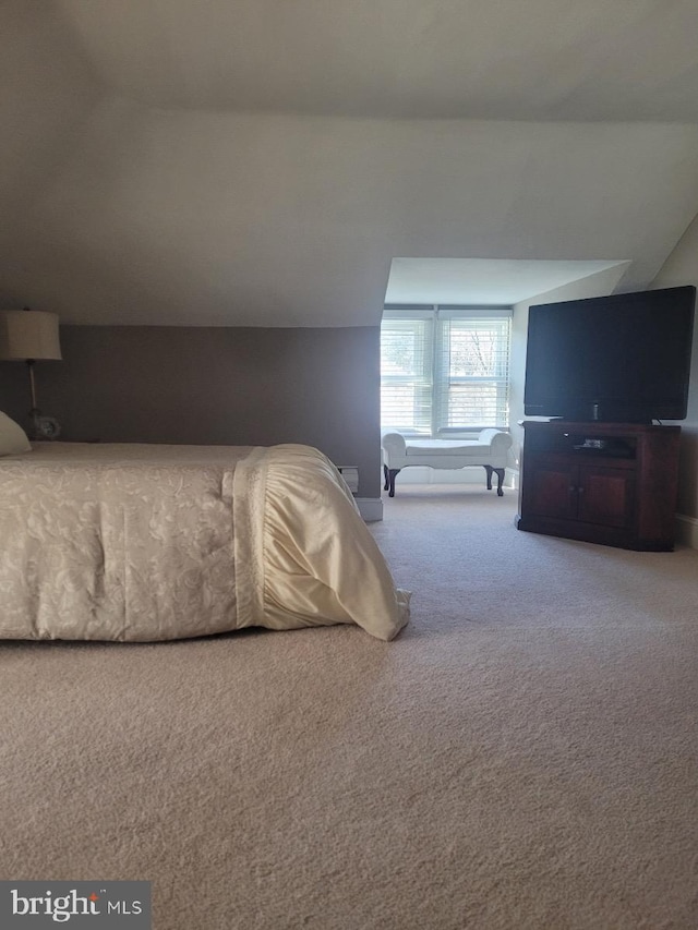 carpeted bedroom featuring lofted ceiling