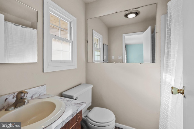 bathroom featuring toilet and vanity