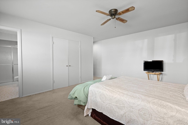 carpeted bedroom featuring ceiling fan and ensuite bathroom