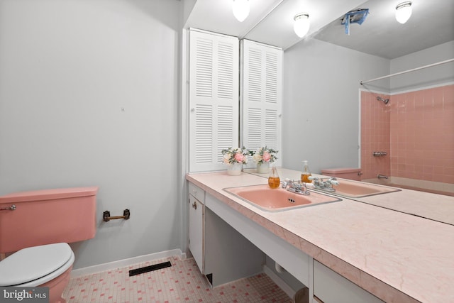 bathroom with tile floors, toilet, and vanity