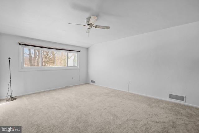 unfurnished room with light colored carpet and ceiling fan