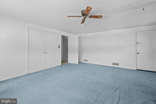 unfurnished bedroom with ceiling fan, light colored carpet, and a closet