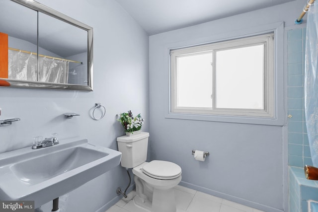 bathroom with toilet, tile flooring, and sink