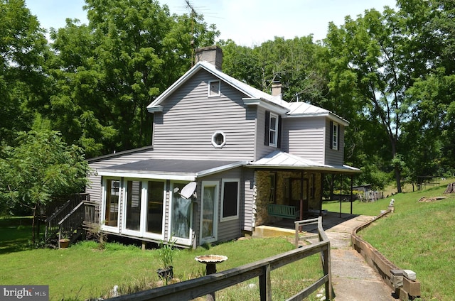 rear view of house with a yard