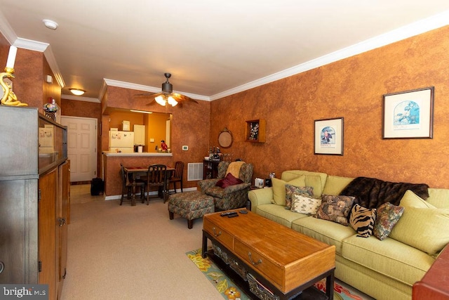 carpeted living room with ceiling fan and crown molding