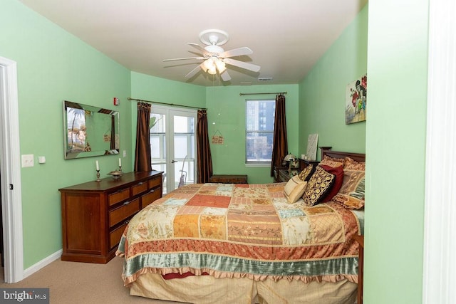 carpeted bedroom with french doors and ceiling fan