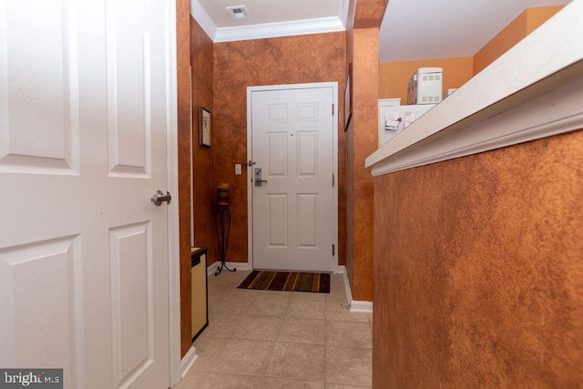 doorway featuring crown molding and light tile floors