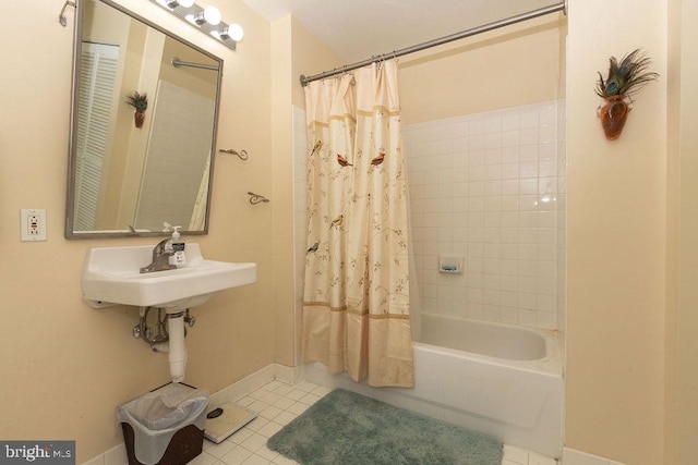 bathroom with shower / bath combo, tile flooring, and sink