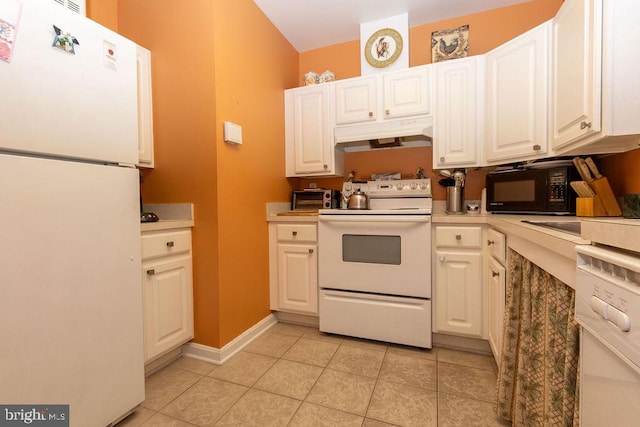 kitchen with white appliances, light tile flooring, and white cabinetry