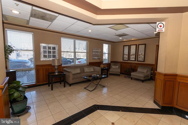 living room featuring ornamental molding and light tile flooring