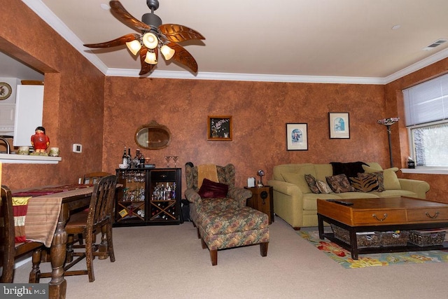 living room with ornamental molding, ceiling fan, and carpet