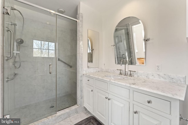 bathroom with tile floors, vanity with extensive cabinet space, and walk in shower