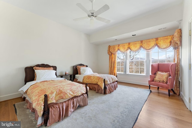 bedroom with light hardwood / wood-style floors and ceiling fan