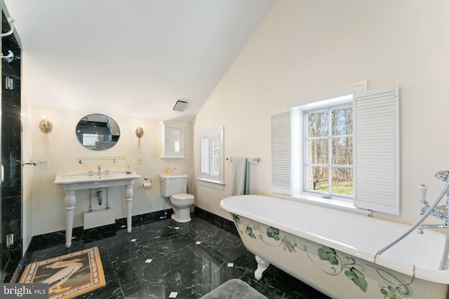 bathroom with tile flooring, toilet, a wealth of natural light, and vaulted ceiling